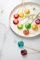 Sugar fruits lollypop candy on light surface