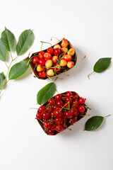Ripe cherry in box on white summer fruits
