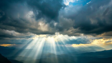 Rays of light shining through dark clouds It's gonna rain, dramatic sky with cloud, Sky background on sunrise nature composition The beam of light through the dark clouds on the mountains.