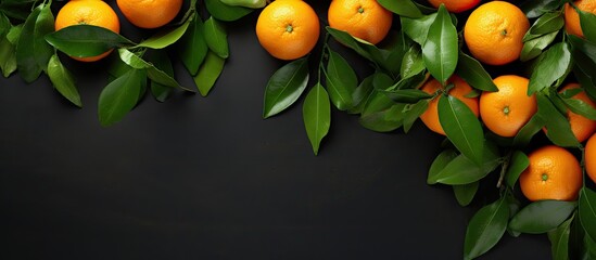 Vibrant Bundle of Citrus Oranges Surrounded by Green Leaves on a Stylish Black Background