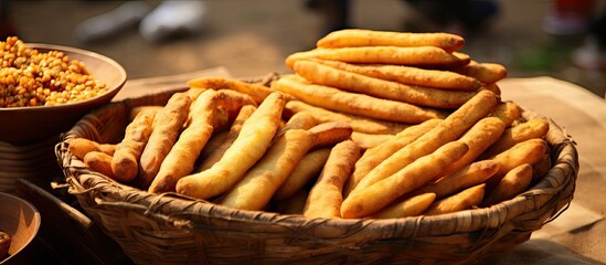 Variety of Crispy Breadsticks in a Rustic Woven Basket on a Wooden Table