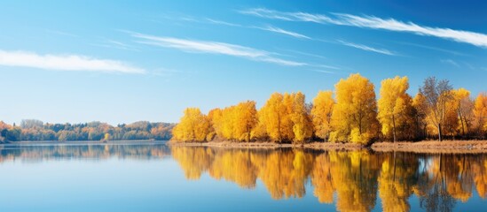 Serene Autumn Scene: Tranquil Lake Surrounded by Colorful Trees and Falling Leaves