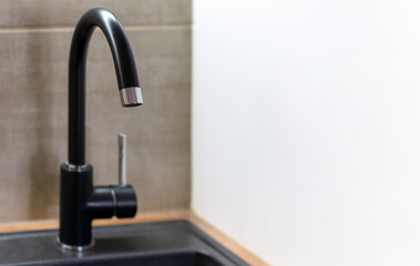 Black kitchen water tap without water. Lack of water.