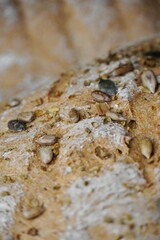 Close-up, homemade bread cut with sunflower seeds, pumpkin and oregano.