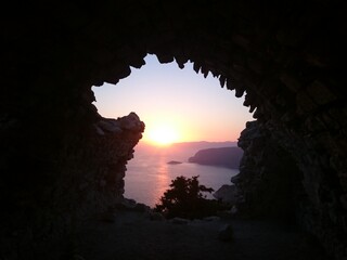 In a cave during sunset
