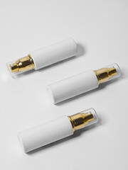 Cosmetic spray and serum bottle on white background