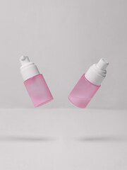 Floating Pink cosmetic serum bottle spray on minimalist white background