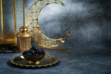 Ramadan Iftar food concept image, Dates on a traditional golden bowl with crescent moon and lantern...