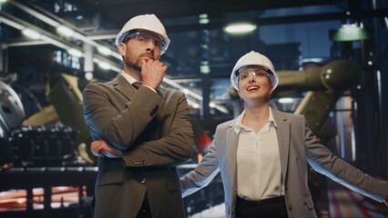 Production owners inspect factory premises in protective helmets close up.