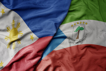 big waving national colorful flag of equatorial guinea and national flag of philippines.