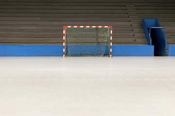 empty sports hall with goals and bleachers