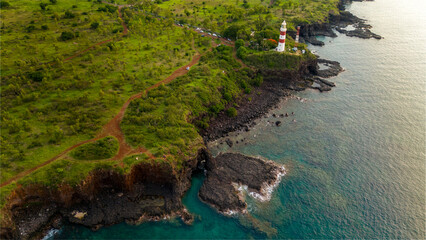 Lighthouse on the cliff over the sea. Mauritius island