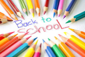 Fototapeta premium Background with colored pencils set and multicolored text Back to school