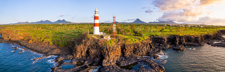 Lighthouse on the cliff over the sea. Mauritius island
