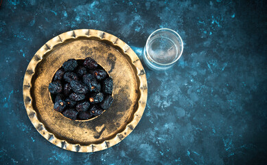 Flatly image of dates with glass of water iftar concept image