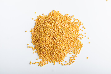 Yellow lentils on a white background. Top view.