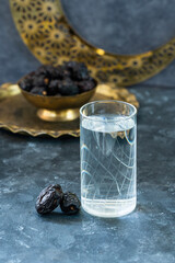 Iftar food minimal type photo, glass of water with dates