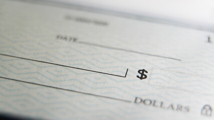 Close-Up view of a  blank check on a desk ready for someone to fill out the necessary details for a...