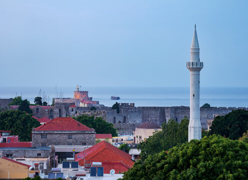 View over Ibrahim Pasha Mosque Minaret and Medieval Old Town towards Saint Nicholas Fortress at dusk, Rhodes City, Rhodes Island, Dodecanese