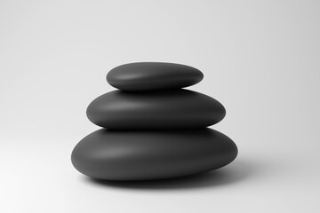 Small pile of black rounded pebbles forming a cairn in white background in monochrome and minimalism. Illustration of the concept of memorials, meditation and relaxation