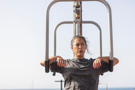 Woman Training at Scenic Seaside Outdoor Gym