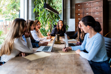 Enthusiastic all-female team in a collaborative meeting