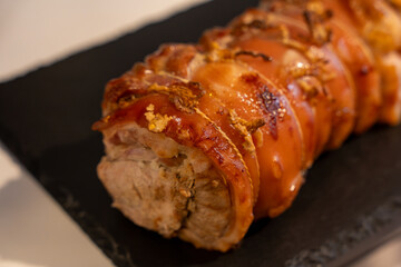 Baked pork wrapped in a roll. Pork roll close-up.