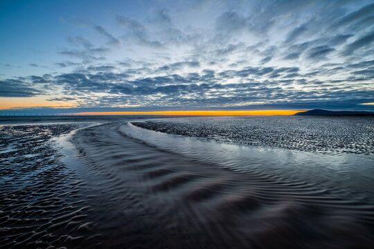Sunset view from Sandy Gap, Walney Island, towards the distant Irish Sea and Black Combe, Walney Island, Lancashire, England