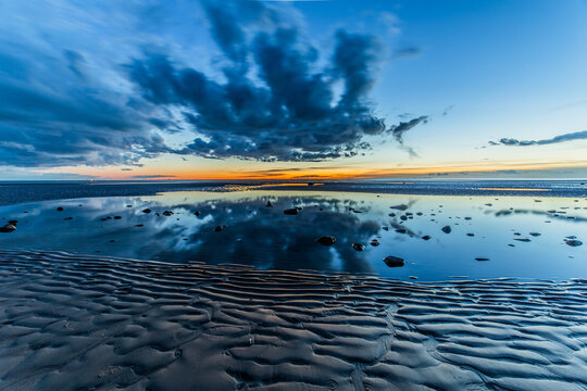Sunset from Sandy Gap on Walney Island, view towards the distant Black Combe across the Irish Sea, Duddon Estuary and Cumbrian Coast, Walney Island, Lancashire, England