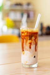 ice caramel macchiato coffee on wooden table.
