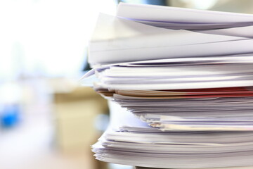 Stack of papers, files, data, archives, profiles and other documentation in the office.