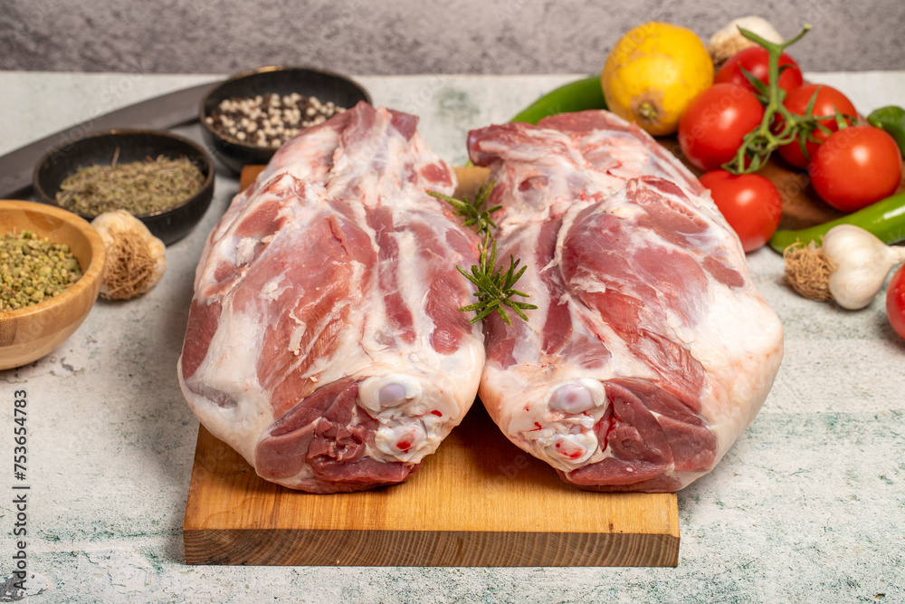 Wall mural leg of lamb butcher products. raw lamb leg meat with bones on stone background