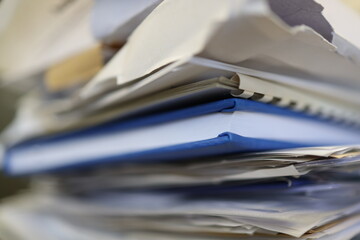 Stack of papers, files, data, archives, profiles and other documentation in the office.