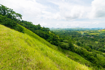 Expansive view over the green hills and valleys of Mabini, Bohol, showcasing the natural beauty and serene landscape of the Philippines.