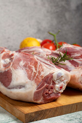 leg of lamb Butcher products. Raw lamb leg meat with bones on stone background