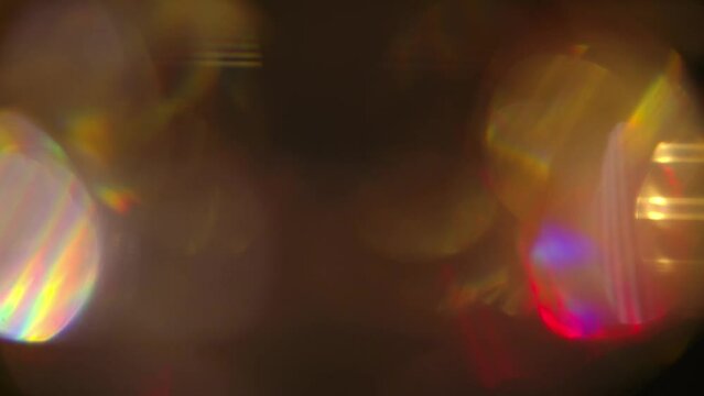 Colorful light leak, lens flare bogeh on dark background. Spectrum, rainbow colors. Motion graphic