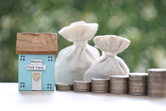 Finance, Model house with money bag on natural green background,Business investment and Save money for prepare in future concept