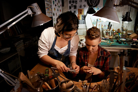 Team, women and tools with jewelry making in workshop with craftsmanship, skill and handmade design for creativity. Fitting, artist and creative people at workspace with top view for handicraft hobby - Powered by Adobe