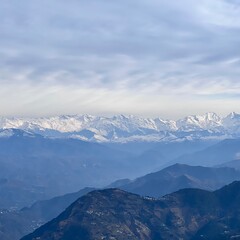 Fototapeta na wymiar Beautiful Dalhousie City of Himachal Pradesh with Dhauladhar mountain range and snowy peaks in the distance. Nature at its best.
