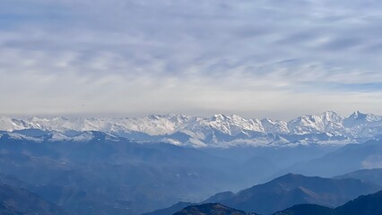 Fototapeta na wymiar Beautiful Dalhousie City of Himachal Pradesh with Dhauladhar mountain range and snowy peaks in the distance. Nature at its best.