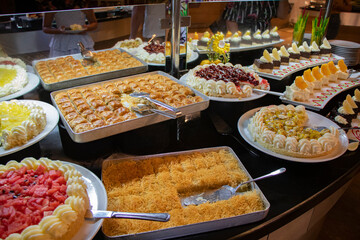 typical turkish delicious desserts baklava and cake with fruits in a restaurant in a hotel in...