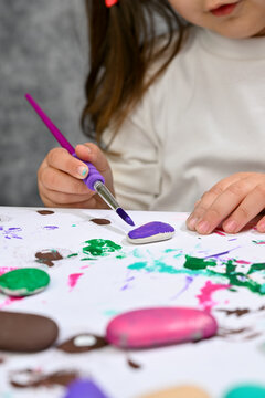 child draws with paints