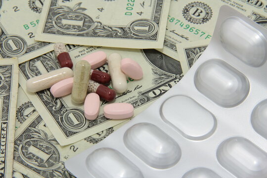 Various pills, drugs on paper USA Dollar money. Expensive medicine.