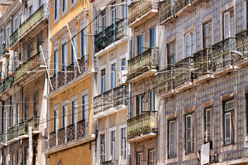Fototapeta premium Cityscape of colorful traditional houses in Lisbon historic center, Portuguese balconies and construction, Portugal