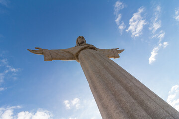 Statue of Christ watching over Lisbon in Almada Portugal, seen diagonal. Address: Alto do Pragal,...