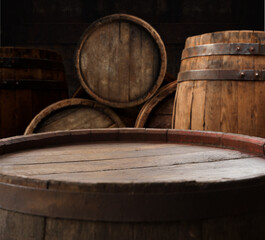 Fototapeta premium table background of free space for your wine bottle or food on top and dark retro interior of barrels . High quality photo