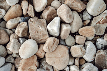 Fototapeta na wymiar Natural rock texture of a colorful pebbles in the beach. Nature backgrounds.