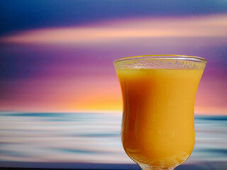 Orange Juice in Bar Glass in front of blurry blinking lights background