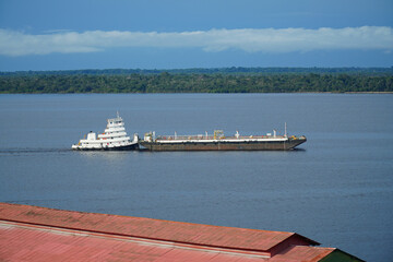 Push boat with a pontoon ship full of oil, an ecological risk posed by cargo ships in the sensitive...