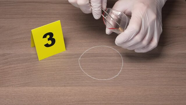 Crime Scene Investigation - forensic officer collecting a bullet casing as a piece of evidence